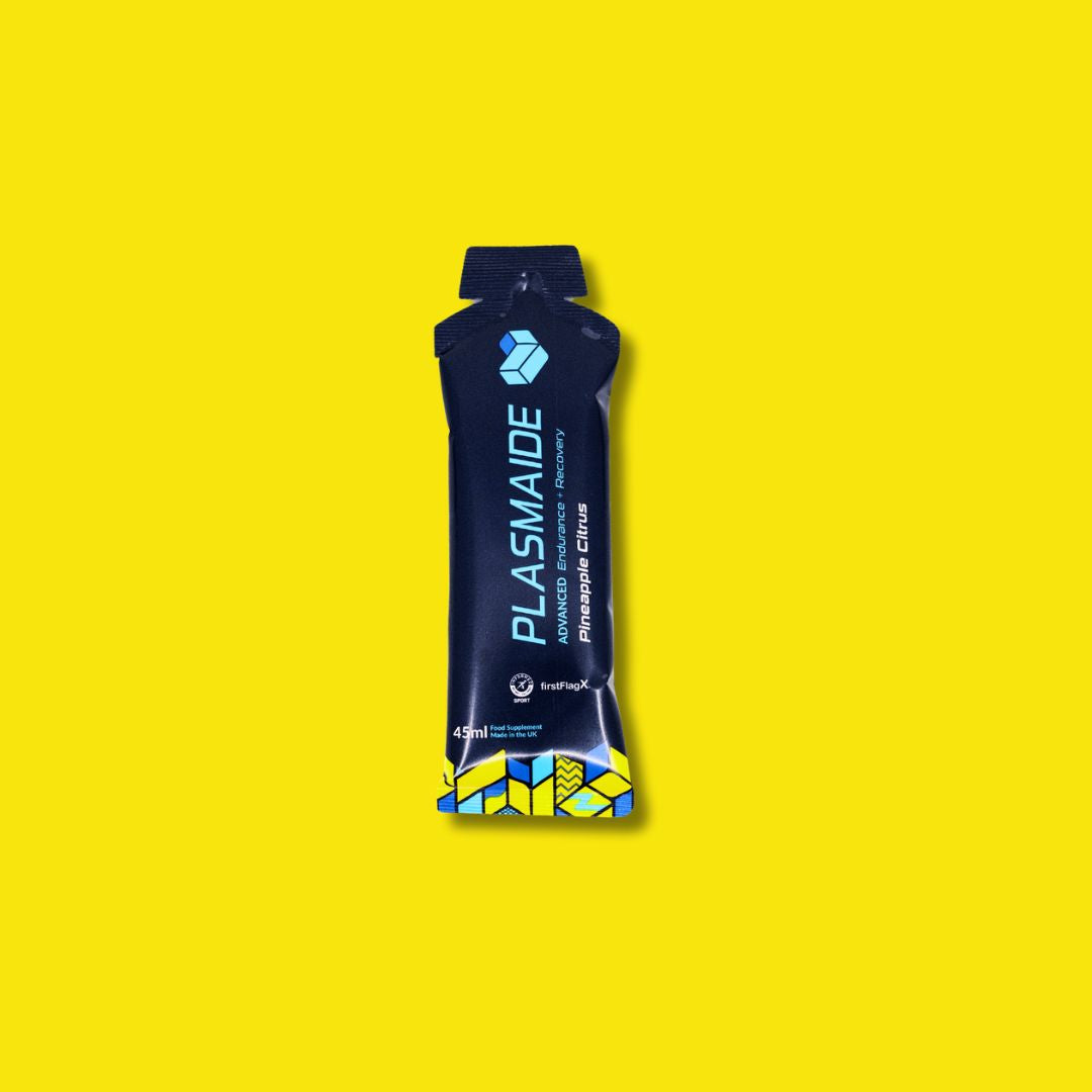 Single-serve Pineapple Citrus beverage by Plasmaide in a clear cup with a straw, showcasing fresh fruit and vibrant citrus slices.