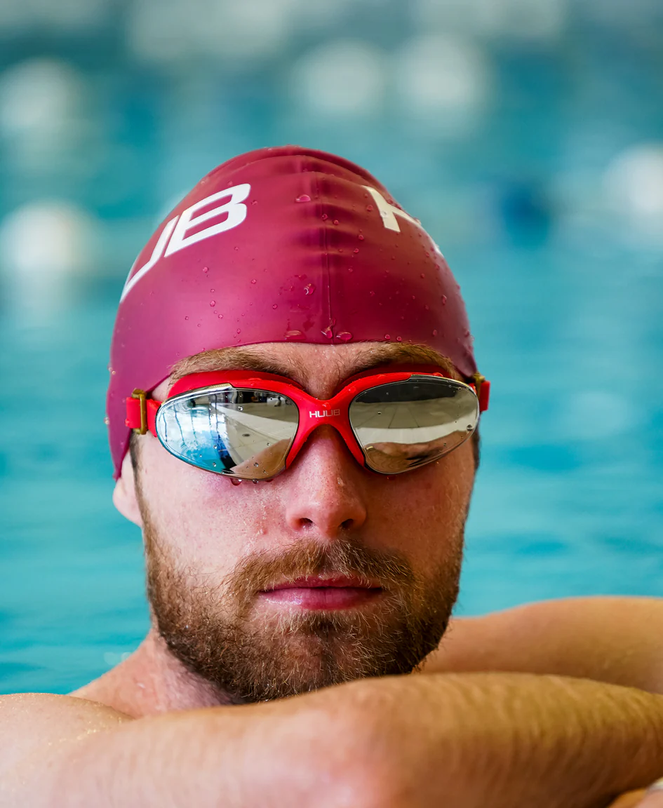 Bright orange HUUB silicone swim cap with a snug fit, designed for comfortable and streamlined swimming.